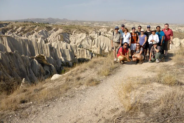 Above Cappadocia's valleys A tour group at a viewpoint overlooking Cappadocia's sculpted rocky valleys.