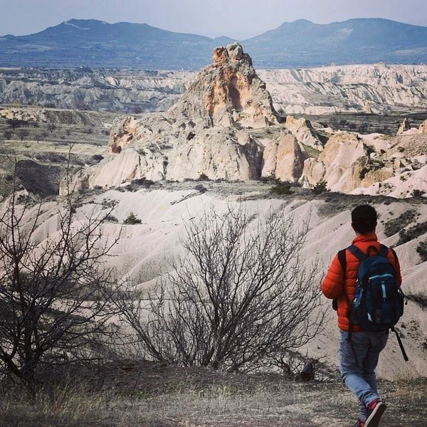 Walking in Cappadocia A traveller walking above Cappadocia's sculpted rocky valleys.