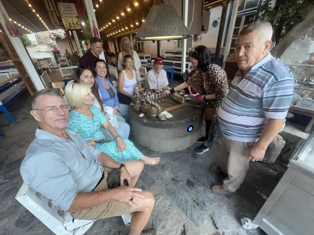Guests and their guide taking a café break together.
