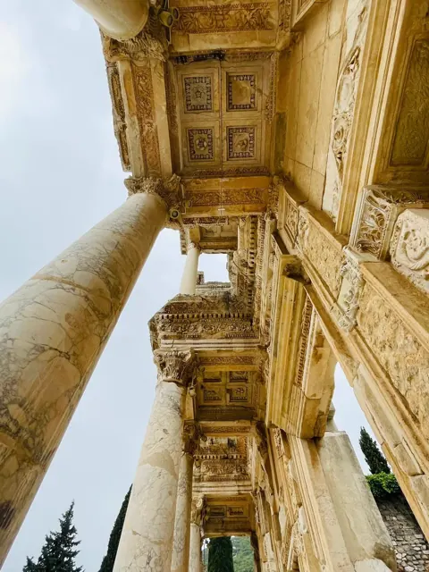 An ornate historic ceiling photographed during a tour.