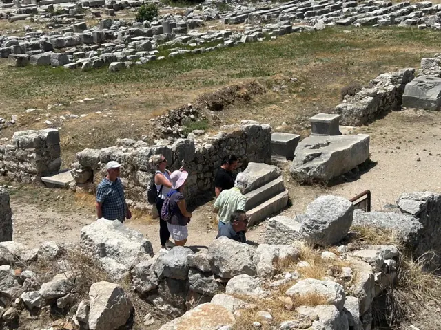 Guests exploring ancient ruins with their guide.