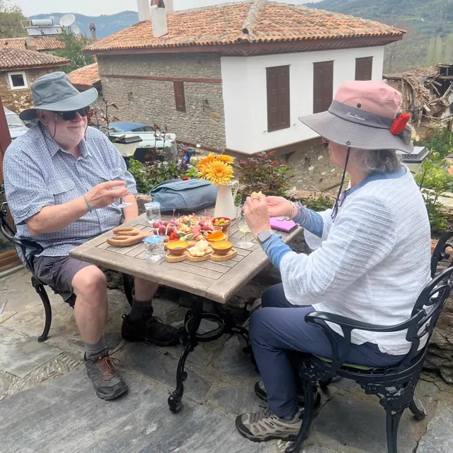 Two guests enjoying an outdoor meal during their trip.