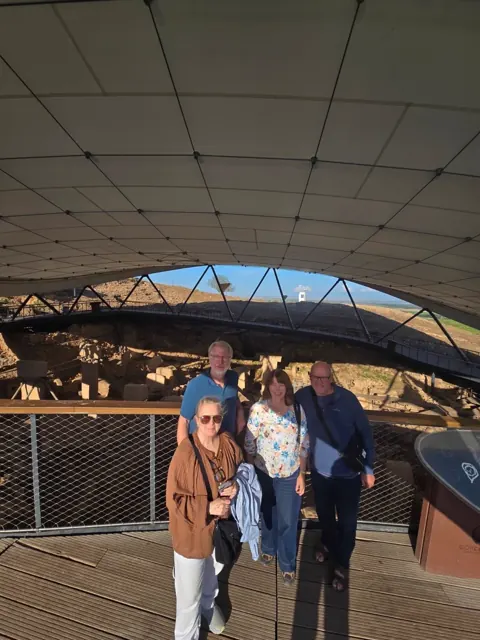 Guests beside the sheltered excavation at Göbekli Tepe.