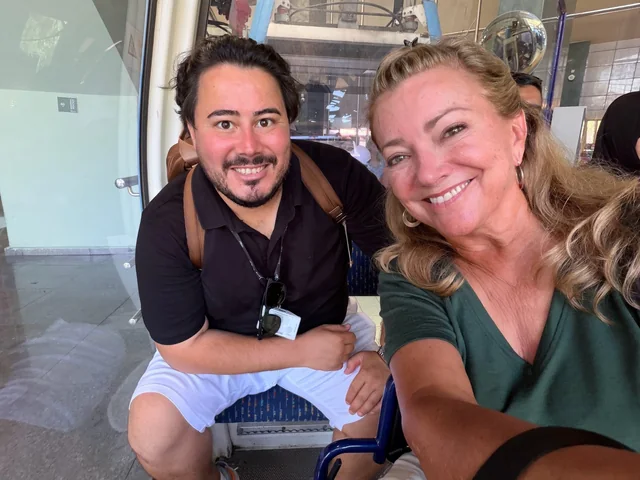 Two travellers sharing a smiling portrait during their visit.