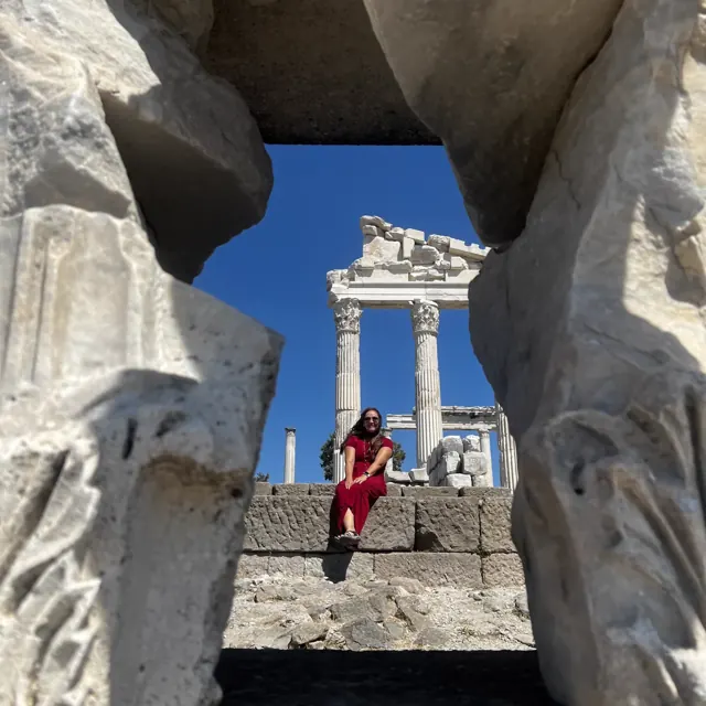 A guest framed by ancient stonework during a heritage visit.